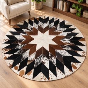 May include: A circular area rug featuring a geometric star pattern constructed from cowhide patches. The design incorporates alternating segments of solid black, solid brown, and white cowhide with brown and black spotted patterns.