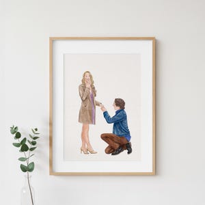 May include: A framed watercolour illustration depicting a person in a tan trench coat standing while another person in a blue denim jacket and brown trousers kneels on one knee, holding out a hand in a proposal gesture on a white background.