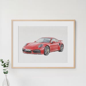 May include: Watercolor painting of a red sports car with a spoiler. The car has a license plate with the number S-GO 4377. The car is set against a white background and framed in a light wood frame.