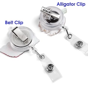 May include: Two clear plastic retractable badge holders with different clip styles. One has a belt clip, the other an alligator clip. Both have a clear plastic strap with a snap closure for attaching a badge.