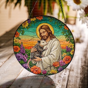 May include: A stained glass window hanging features a colorful depiction of Jesus holding a possum. The background is a vibrant landscape with flowers and a sunset.