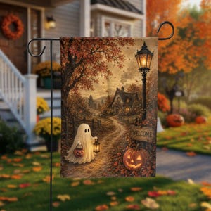 May include: A rectangular garden flag featuring an autumn scene with a white ghost holding a pumpkin bucket and a lantern on a dirt path. A lit streetlamp, a cottage, and a sign that reads WELCOME stand near a large carved jack-o'-lantern.