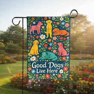 May include: A decorative garden flag featuring colorful illustrations of dogs in various poses, surrounded by flowers. The flag has the text "Good Dogs Live Here" on a dark blue background. The flag is hanging on a black metal stand.