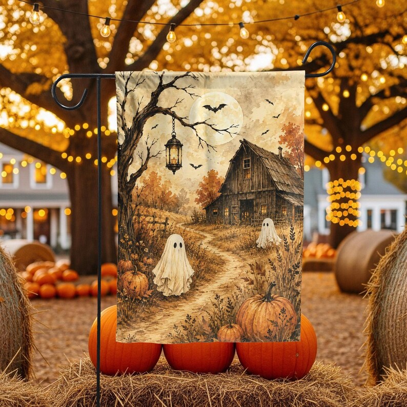 May include: A rectangular garden flag featuring a Halloween scene with two white ghosts, orange pumpkins, a rustic wooden barn, a hanging lantern, and a full moon in a tree-lined landscape. The artwork displays a warm autumn color palette.