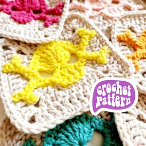 May include: Close-up of several crocheted skull motifs in various colors, including pink, yellow, orange, and teal, on a neutral background. The image includes a purple speech bubble with the words "crochet pattern".