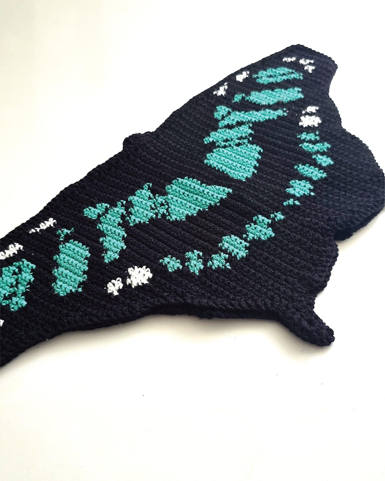 Close up tapestry crochet chart motif, malachite butterfly design in teal and black, crochet pattern detail
