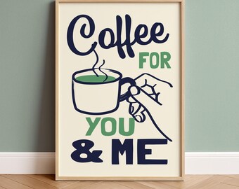 May include: Framed art print with a cream background featuring the words "Coffee FOR YOU & ME" in navy and green. A hand holds a coffee cup with green liquid and steam rising from it. The artwork is in a wooden frame.