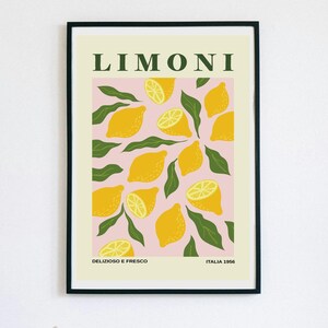 May include: A framed art print featuring a pink background with yellow lemons and green leaves. The word "LIMONI" is at the top, with "DELIZIOSO E FRESCO" and "ITALIA 1956" at the bottom. The print has a black frame.