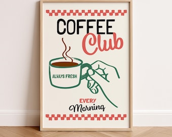 May include: Framed art print with a coffee theme. The print features the words "COFFEE Club" in black and red, with a coffee cup and hand illustration. The words "ALWAYS FRESH" are on the cup, and "EVERY MORNING" is below.