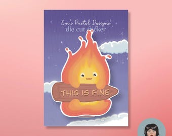 May include: A die-cut sticker featuring a cartoon flame character with a smiling face, holding a wooden sign that reads "THIS IS FINE." The background is a purple night sky with clouds and stars. The sticker has the text "Em's Pastel Designs" at the top.