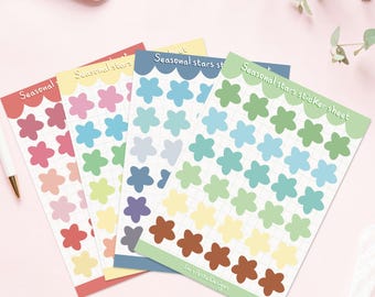 May include: Four sticker sheets with colorful flower designs. Each sheet has a different color border and features the text "Seasonal stars sticker sheet". The flowers are in shades of red, pink, yellow, green, blue, and brown.
