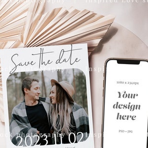 May include: A mock-up featuring a 'Save the Date' card with a couple's photo and the date '2023 11 02'. A smartphone displays 'Your design here'. The background includes a dried palm leaf and a neutral-toned surface.
