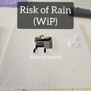 May include: A work in progress (WIP) bead sprite of the Enforcer from the video game Risk of Rain. The sprite is made of black, white, and orange beads on a white pegboard.