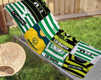 Puede incluir: Una toalla de playa verde y amarilla con un diseño de patchwork que presenta diferentes logotipos de patrocinadores, incluidos Carling, Dafabet y CR Smith.