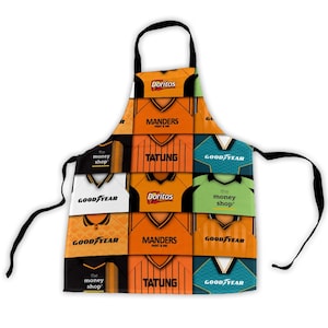 May include: A patchwork apron featuring a design of football jerseys in orange, white, and teal. The jerseys display sponsor logos and team names including "Doritos," "Manders," and "Goodyear." The apron has a black neck strap and ties.