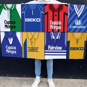 May include: A collage of nine colourful football jerseys with various team names and sponsors, including "Captain Morgan", "BEKO", "Fairview", and "Lewisham".