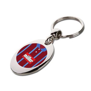 May include: Silver oval keyring featuring a maroon and blue striped jersey design. The keyring has a silver ring and a small image of a jersey with the word "müller" in a red box.