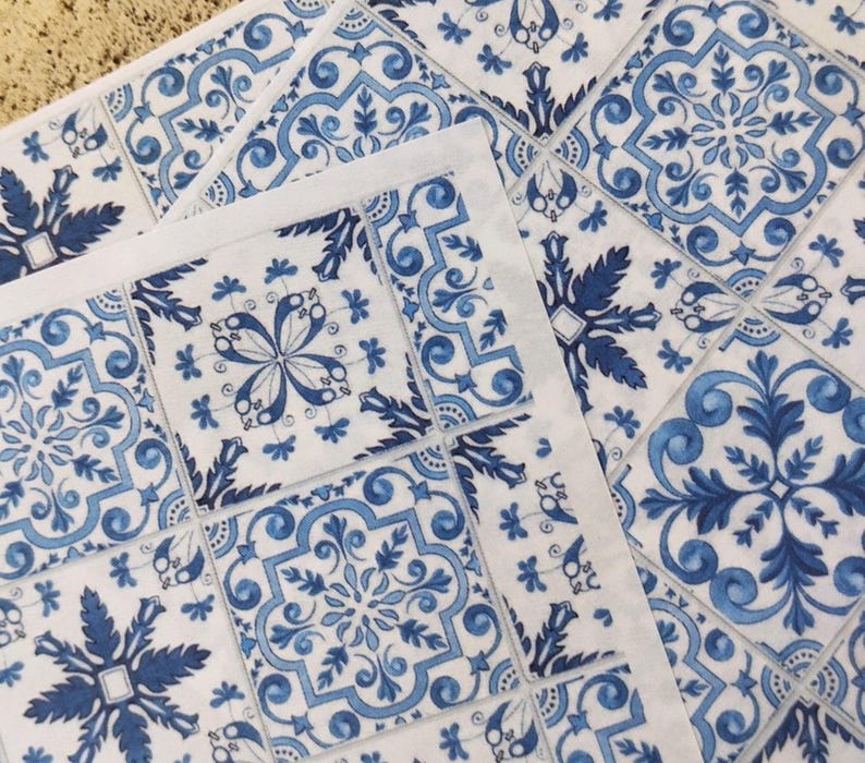May include: Blue and white patterned tile stickers with a floral design. The stickers are arranged in a grid pattern.