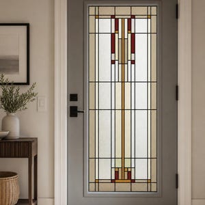 May include: A gray door featuring a tall, rectangular stained glass window insert. The glass displays a geometric pattern with clear, cream, and deep red panes framed by black metal lines. A black handle and lock set are mounted on the left side.