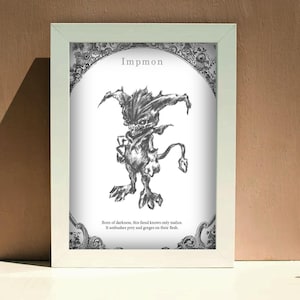 May include: A framed black and white illustration of Impmon, a demonic creature with sharp features and a tail. The artwork is in a white frame and includes text at the top and bottom. The background is a neutral color.