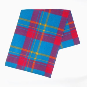 May include: A folded scarf with a vibrant plaid pattern. The design features a bold combination of blue, red, purple, orange, and yellow lines. The scarf is made of a soft material and is suitable for various occasions.