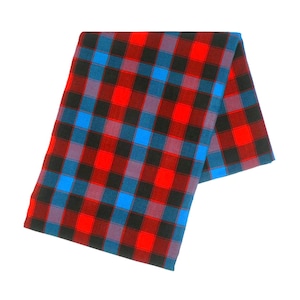 May include: A folded plaid fabric in a red, black, blue, and purple checkered pattern. The fabric is folded over on itself, with the pattern visible on both sides. The fabric is likely a textile, such as cotton or wool.