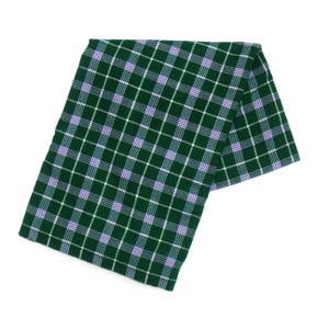 May include: A folded green and white plaid scarf with a hint of purple. The scarf is made of a soft material and is displayed on a white background. The plaid pattern is a classic design.