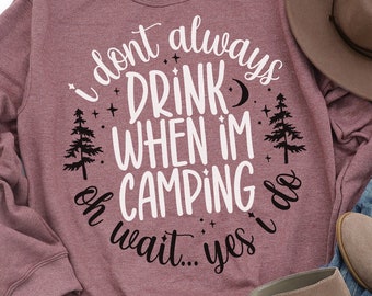May include: A mauve sweatshirt with the text "I don't always drink when I'm camping...oh wait...yes I do" in a circle with a moon, stars, and pine trees.