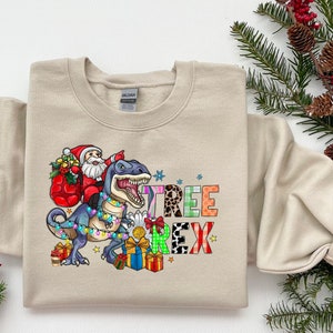 Christmas T-Rex Toddler Sweatshirt, Santa riding Dinosaur Christmas shirt, T-Rex Christmas Shirt, Funny Christmas Party Shirt Dino Lover Tee