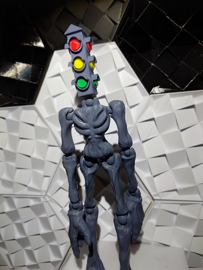 May include: A gray articulated skeleton figure with a traffic light head. The traffic light has red, yellow, and green lights.
