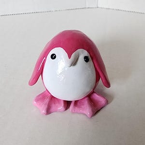 Peluche ronde et ronde en forme de pingouin rose en pâte polymère