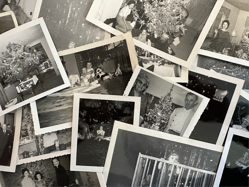 May include: A collection of black and white photographs of families celebrating Christmas. The photos show people of different ages, including children, adults, and seniors, posing in front of decorated Christmas trees and holding gifts.