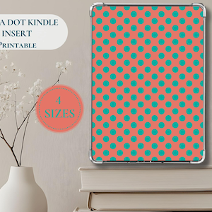 May include: A Kindle insert with a coral background and teal polka dots. The insert is displayed in a clear case. Text on the image reads "Polka Dot Kindle Insert Printable" and "4 Sizes". A white vase with flowers and books are in the background.