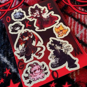 May include: A set of nine stickers featuring various cartoon characters. The stickers are on a red background with black outlines. The characters include a red devil, a black cat, a yellow bird, and a black and white character with a cigarette. The stickers are labeled with the letters "O", "K", "E", "G", "M", and "O".