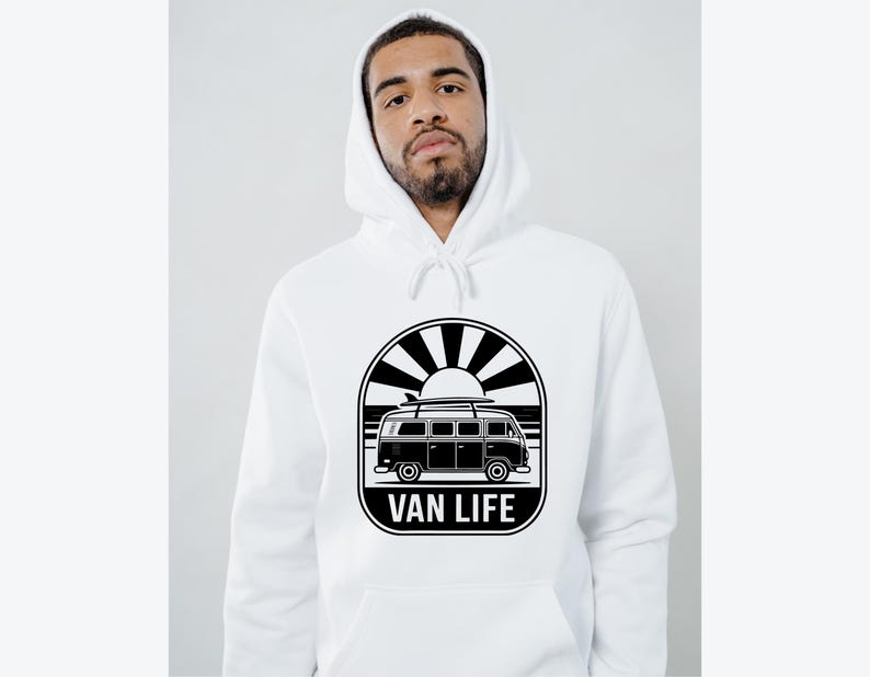 May include: White hoodie featuring a black and white graphic of a van with a surfboard on top, set against a sunburst design. The text "VAN LIFE" is displayed below the van. The hoodie has a drawstring hood.