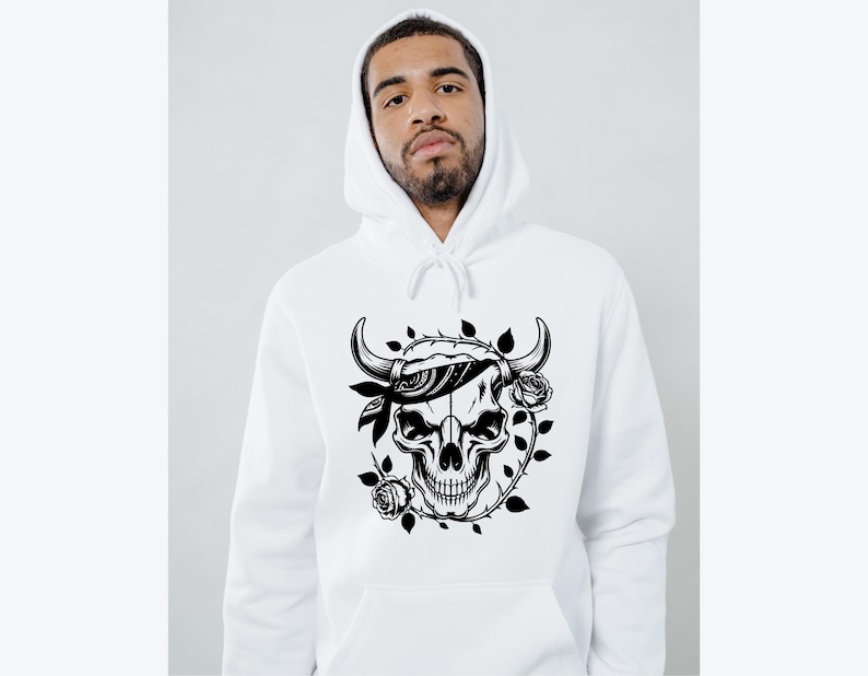 May include: White hooded sweatshirt featuring a black and white graphic of a skull with horns, a bandana, and roses. The design is centered on the front of the hoodie. The hoodie has a drawstring and a kangaroo pocket.