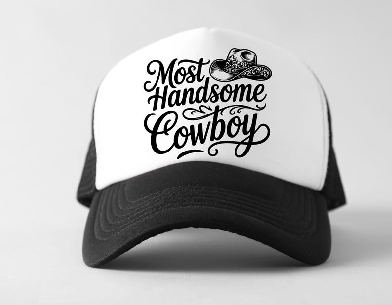 May include: A black and white trucker hat with the text "Most Handsome Cowboy" in a stylish script. The hat features a white front panel with a cowboy hat graphic and a black brim and mesh back.