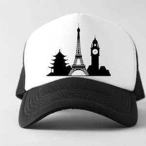 May include: A black and white trucker hat featuring a silhouette design of famous landmarks. The design includes a pagoda, the Eiffel Tower, and Big Ben. The hat has a white front panel and a black mesh back and brim.