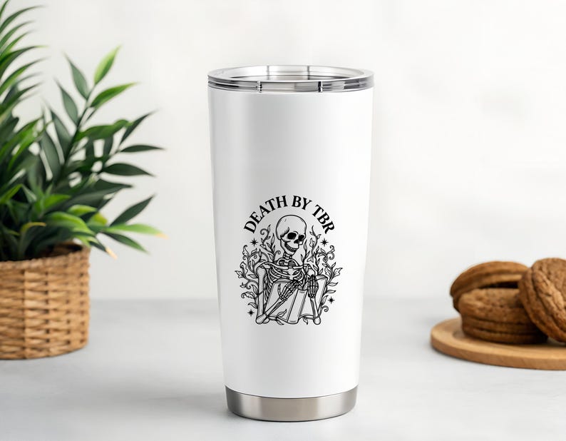 May include: White stainless steel tumbler with a black graphic of a skeleton reading a book, surrounded by foliage, and the text "DEATH BY TBR". The tumbler has a silver base and lid.