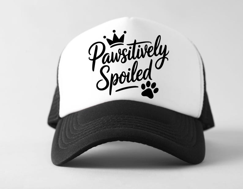May include: A black and white trucker hat with the text "Pawsitively Spoiled" in a script font, a crown, and a paw print. The hat has a white front panel and a black mesh back.
