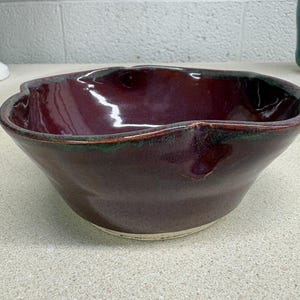 May include: A rustic wooden sign with the text "Welcome to our home" in white lettering. The sign features a distressed finish and a simple, inviting design, perfect for a front porch or entryway.