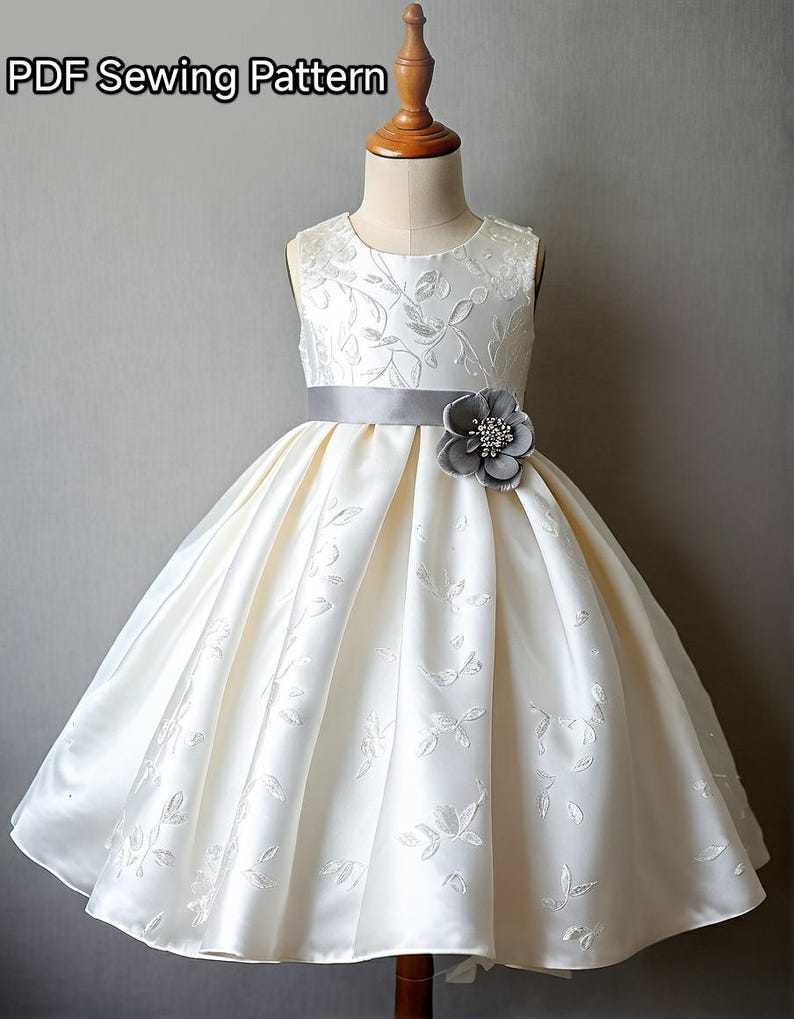 May include: A white sleeveless dress with a gray satin sash and a gray flower embellishment. The dress has a floral pattern and a full skirt.  PDF Sewing Pattern.