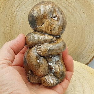 Raku ceramic Buddhababa, or Baby Buddha from marbled clay