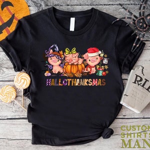 a black t - shirt with three cartoon characters on it