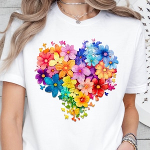 a woman wearing a t - shirt with a heart made of flowers