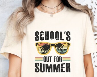 May include: A white t-shirt with the text "School's Out For Summer" in black lettering. The text is surrounded by a graphic of sunglasses with palm trees reflected in the lenses.