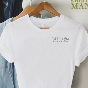 May include: White t-shirt with the text "Yes I'm single, now is your choice" printed on the front.