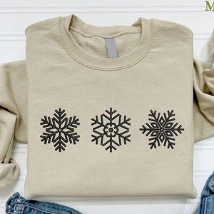 a pair of jeans and a sweater with snowflakes on them