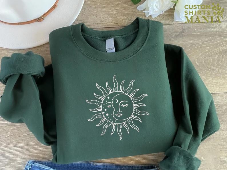 a green sweatshirt with a sun on it