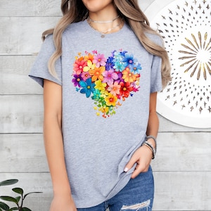 a woman wearing a t - shirt with a heart made of flowers